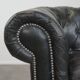 Black Chesterfield armchair made of grained cowhide leather