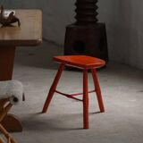 Pair of patinated wooden stools painted red with flared legs, 1950s-1960s.