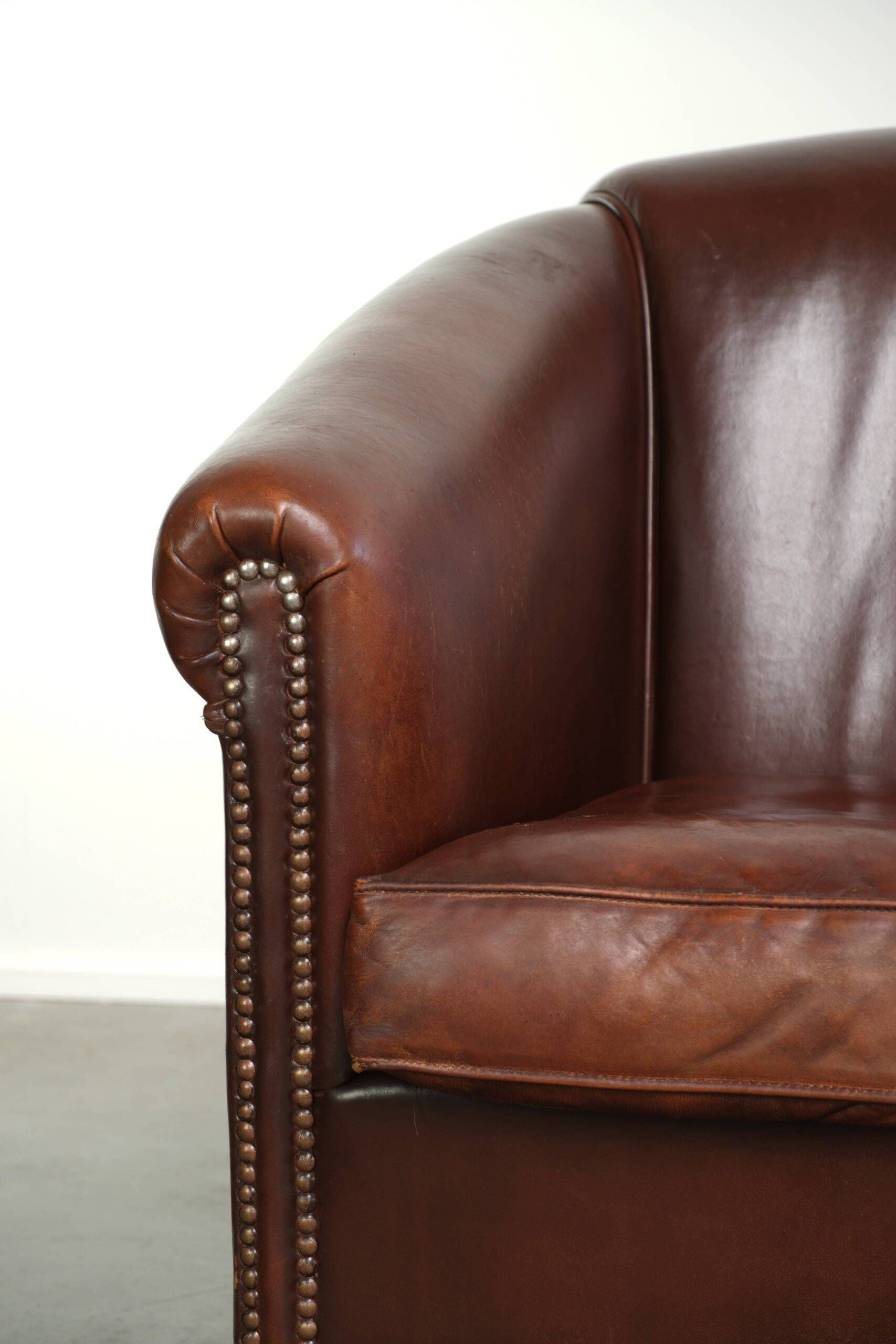 Set of 2 sheepskin club armchairs in a dark cognac colour