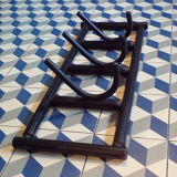 Articulated coat rack in blackened wood