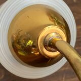 Gold metal wall light with ribbed glass.