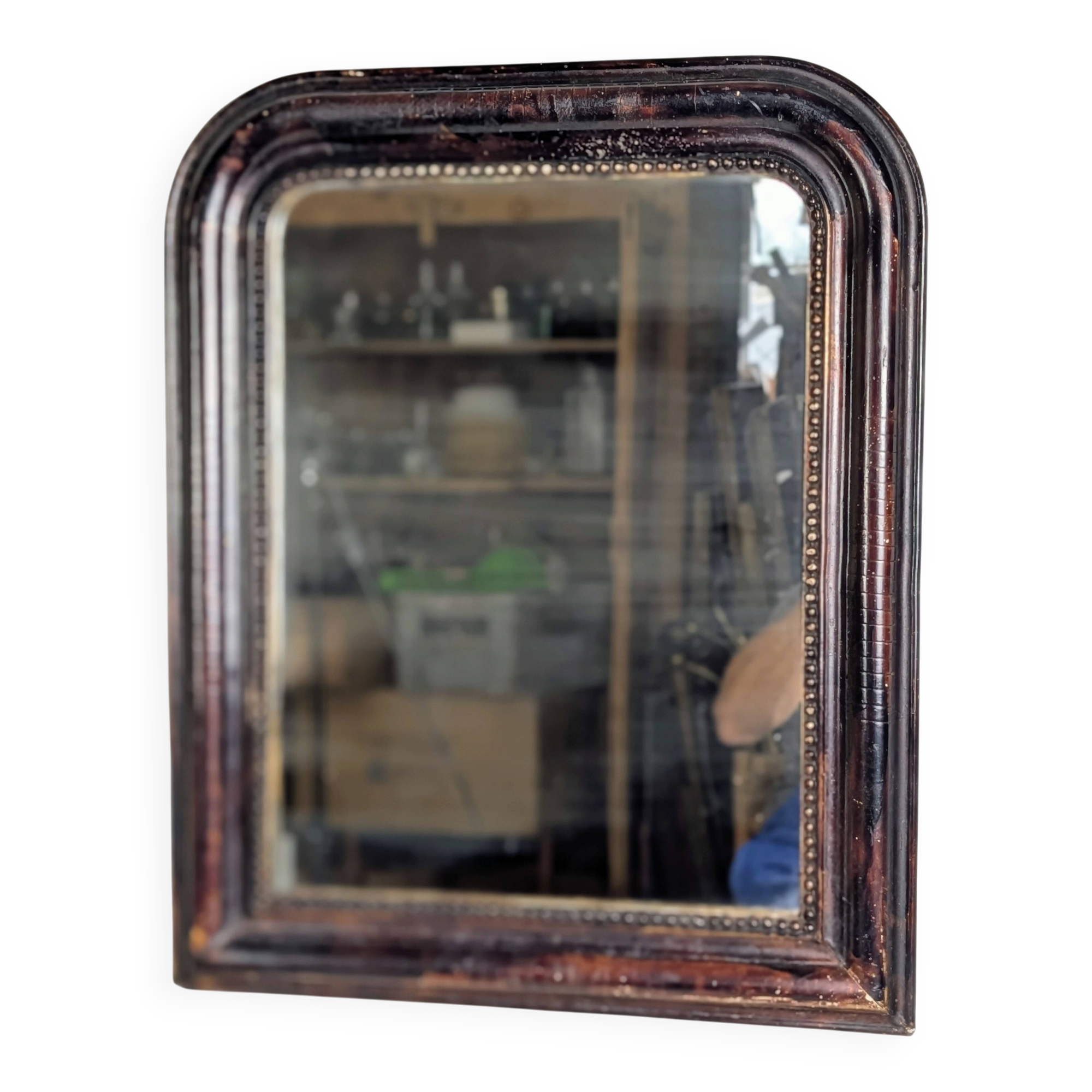 Antique Louis Philippe mirror with a patinated black frame.