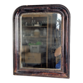 Antique Louis Philippe mirror with a patinated black frame.