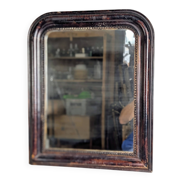 Antique Louis Philippe mirror with a patinated black frame.