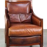 Comfortable Art Deco design armchair in cognac-colored sheepskin combined with wood