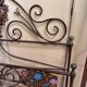 Venetian bed in iron and cast iron from the Art Nouveau period with polychrome decorations