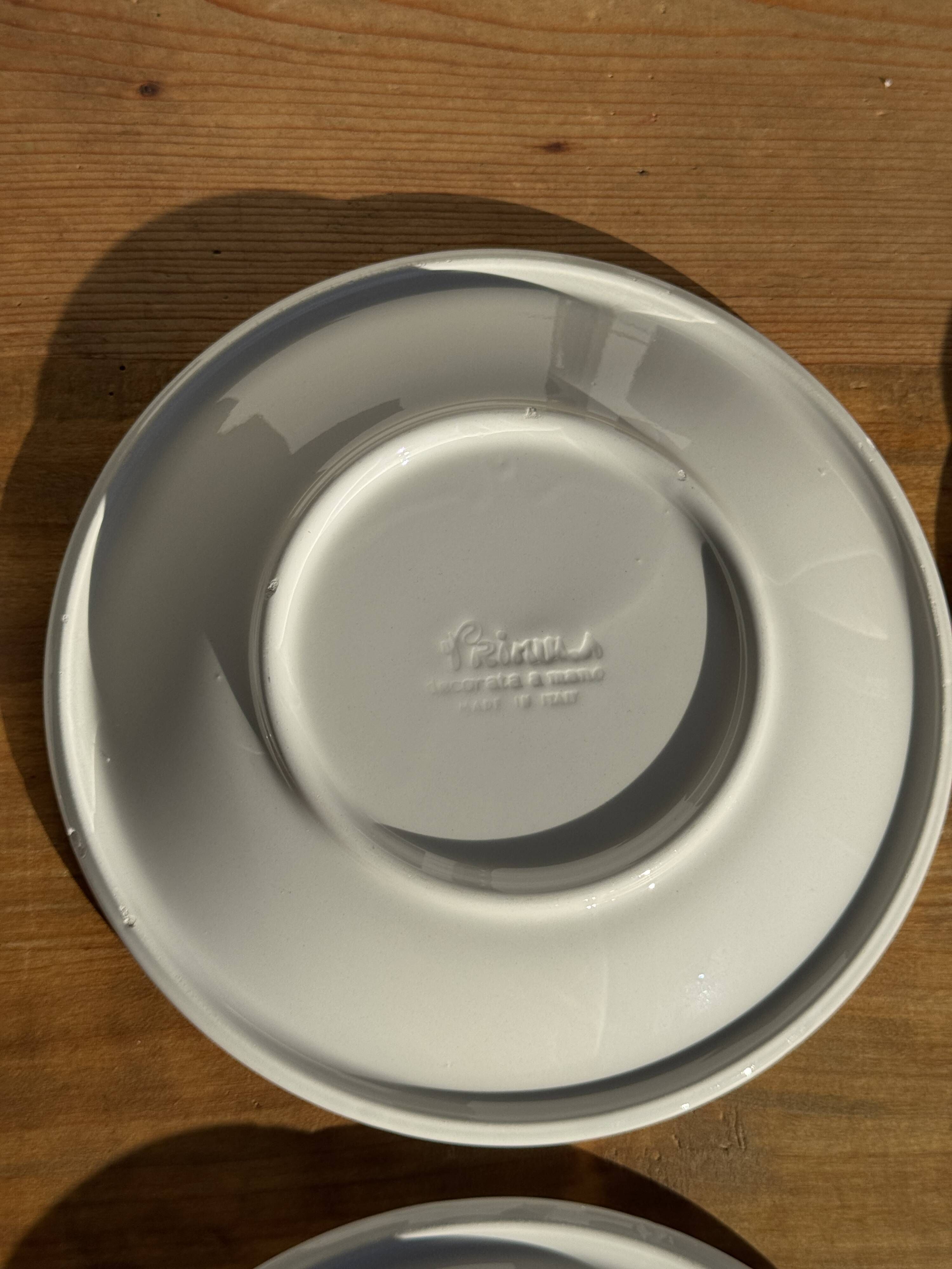 Set of 9 small Italian dessert plates Primula with red and green trim.