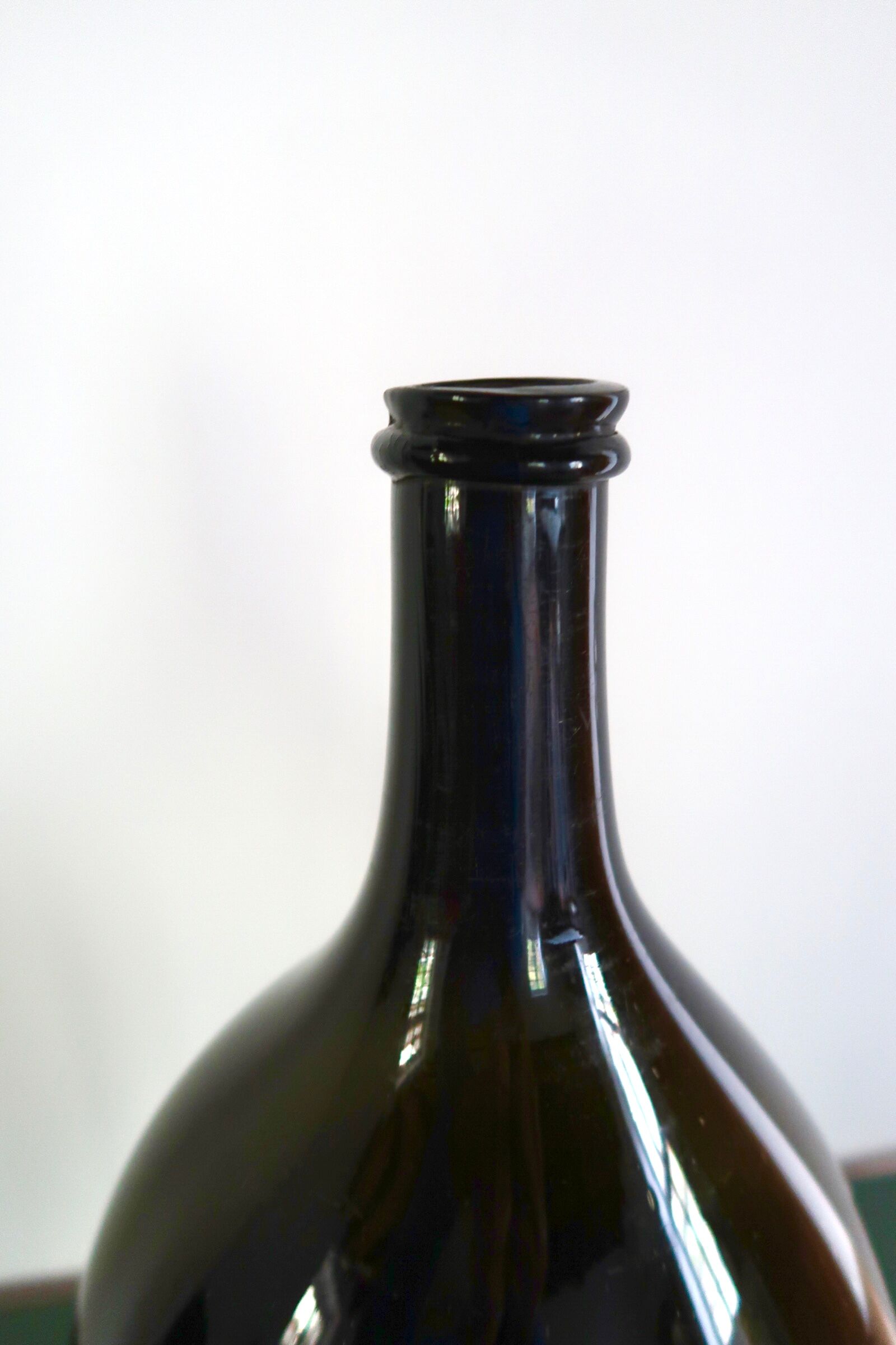 Large old bottle dame-jeanne dark green