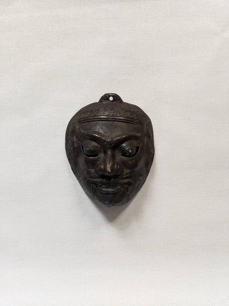 Ancient Indonesian bronze mask antique ethnic decoration tribal theater