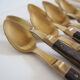 Set of old dessert cutlery in wood and brass