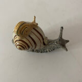 Porcelain figurine snail and its small