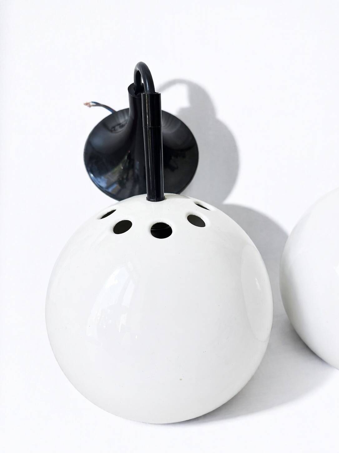 Two white metal globe pendant lights, 1970s.