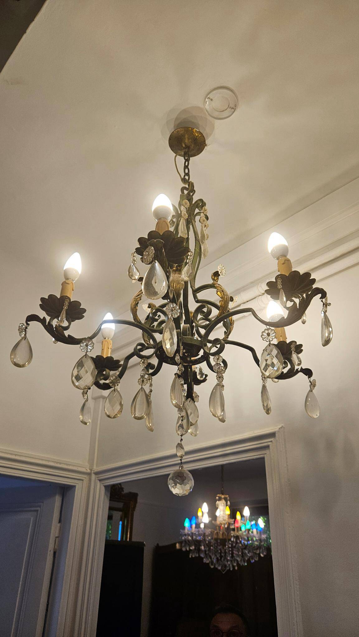 Antique wrought iron chandelier with 6 lights and pendants.