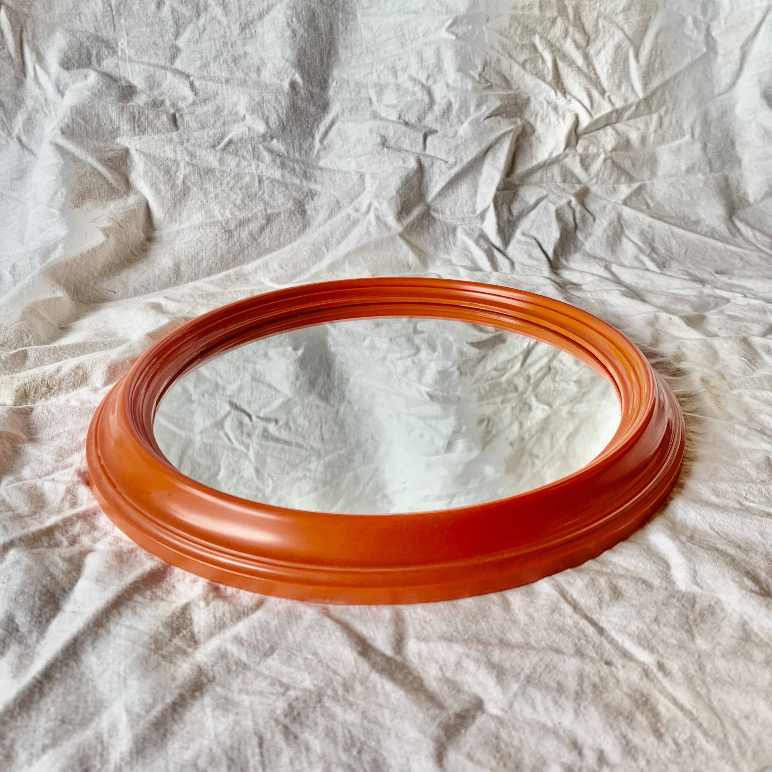 Vintage orange plastic oval wall mirror