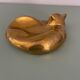 Cat-shaped catchall that looks like it's sleeping.