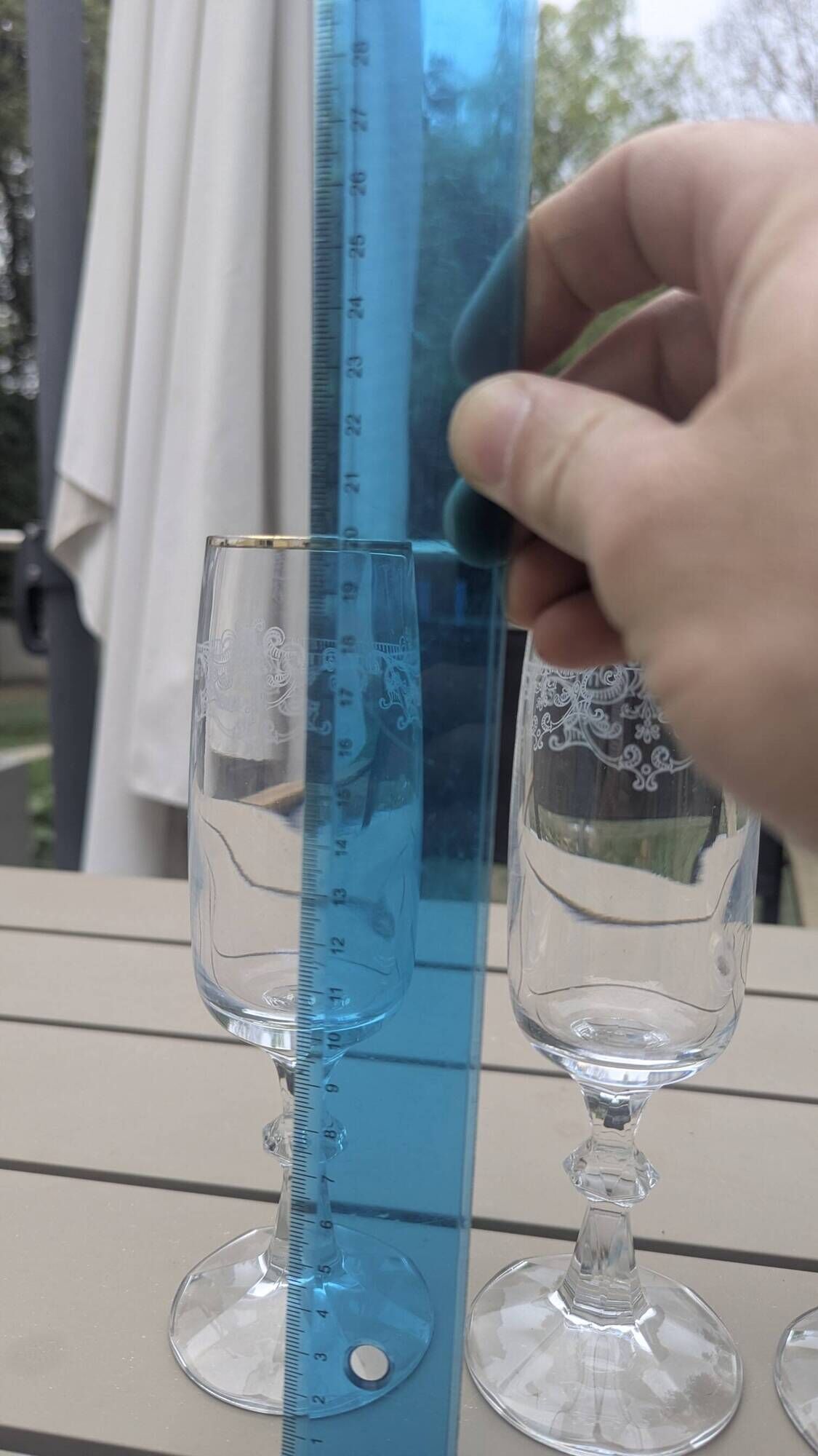 Set of 15 engraved crystal glasses with a gold rim.