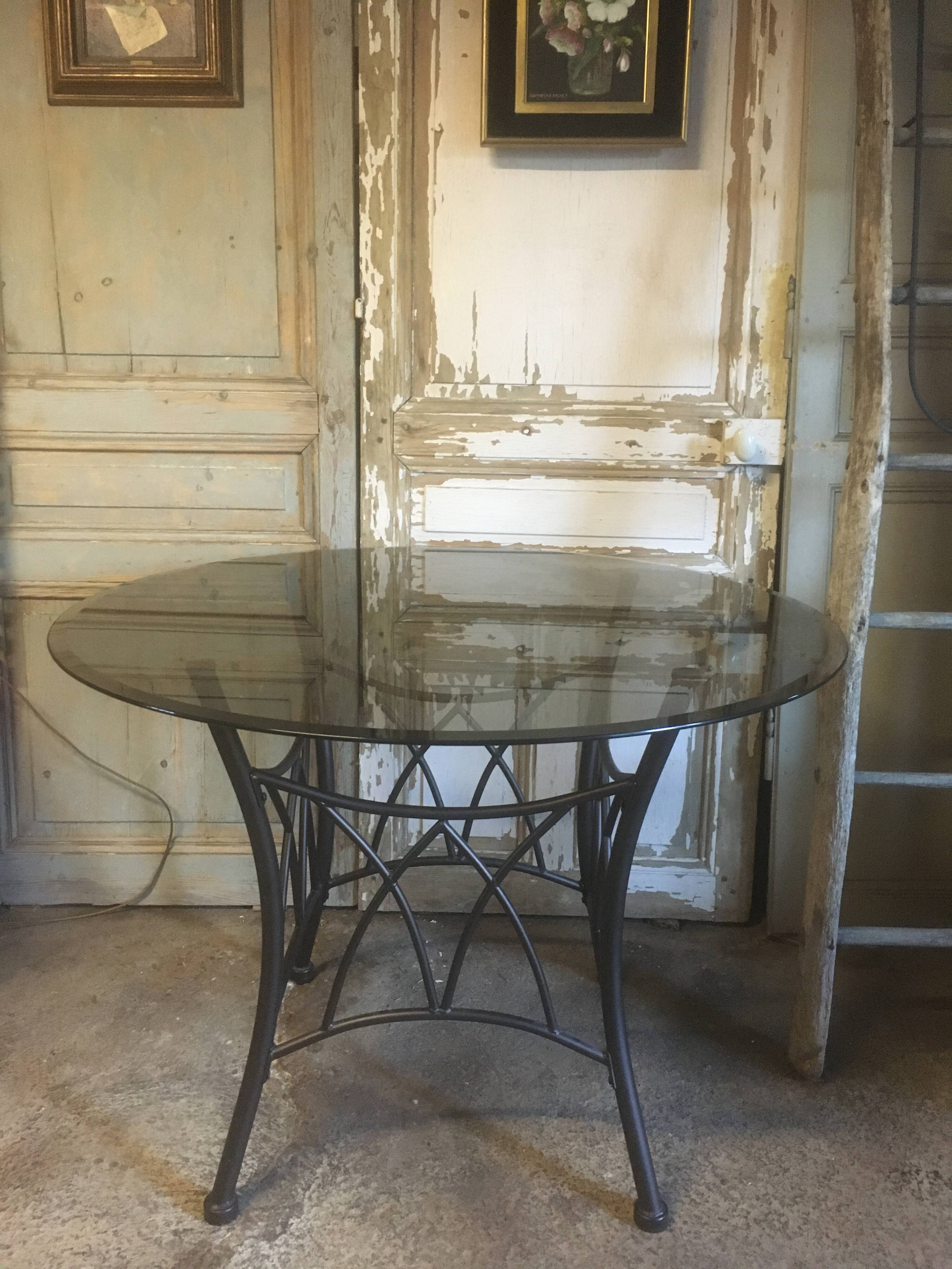 Round table with metal legs and smoked glass