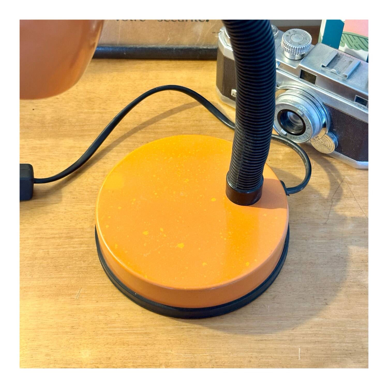 Orange articulated desk lamp