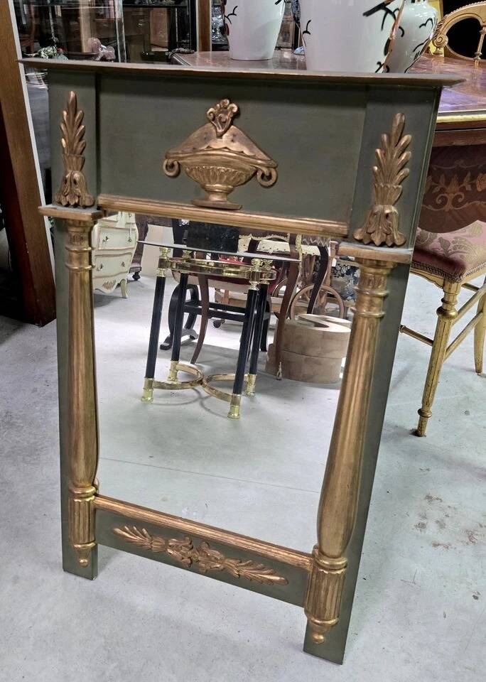 Empire-style mirror in deep green lacquered wood richly enhanced.