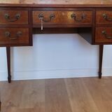 English wooden desk on top of leather