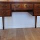 English wooden desk on top of leather