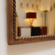 Lighting mirror in gilded wrought iron