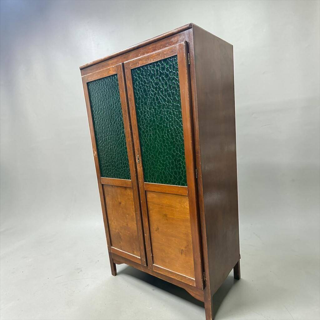 Vintage wooden display cabinet with green glass.