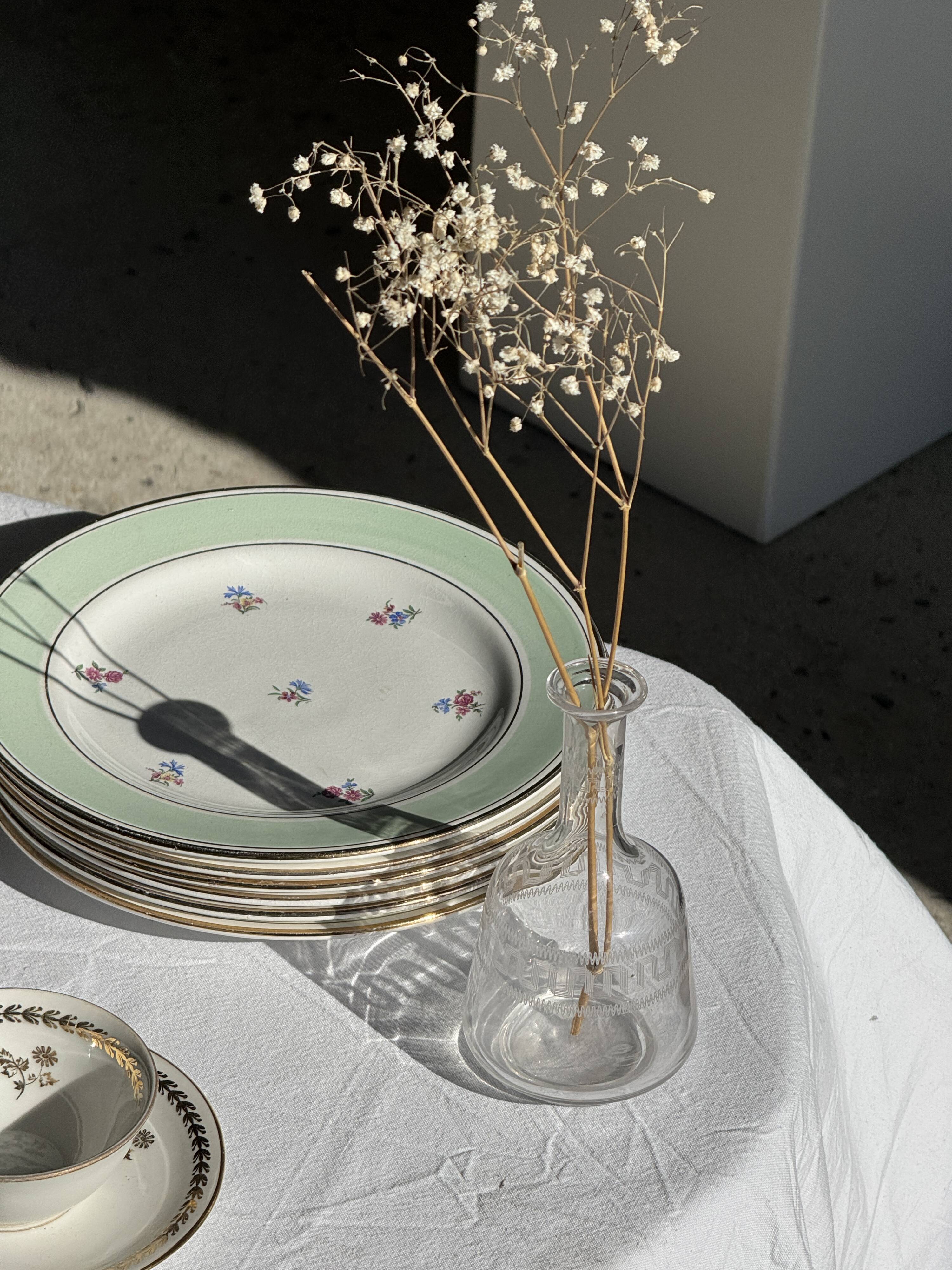 Set of 9 vintage turquoise deep plates with gold trim and pink flowers.