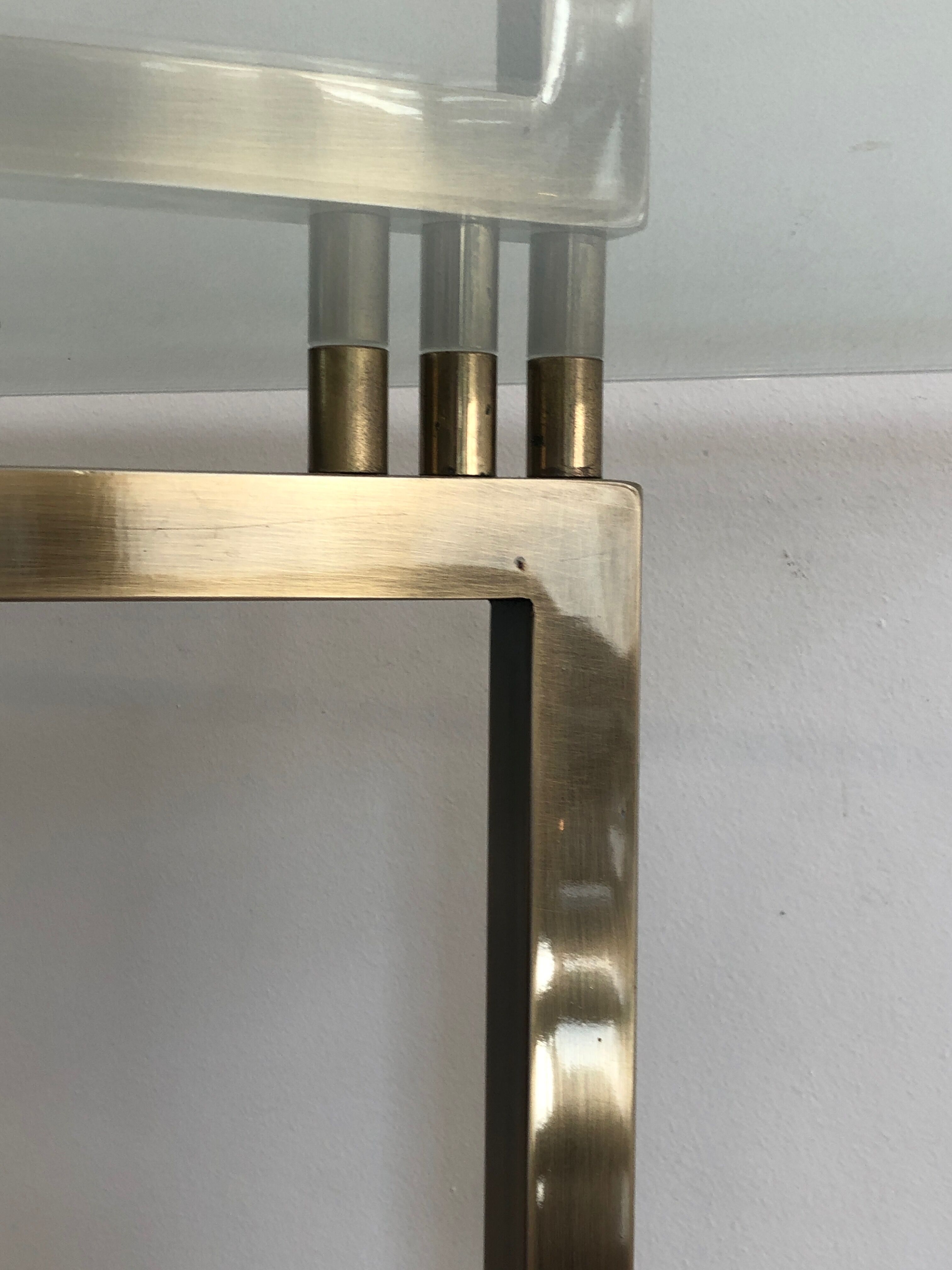 Console in brushed steel and brass and tray formed of a glass slab. French work. Around 1970