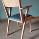 Scandinavian armchairs with green tapered legs.