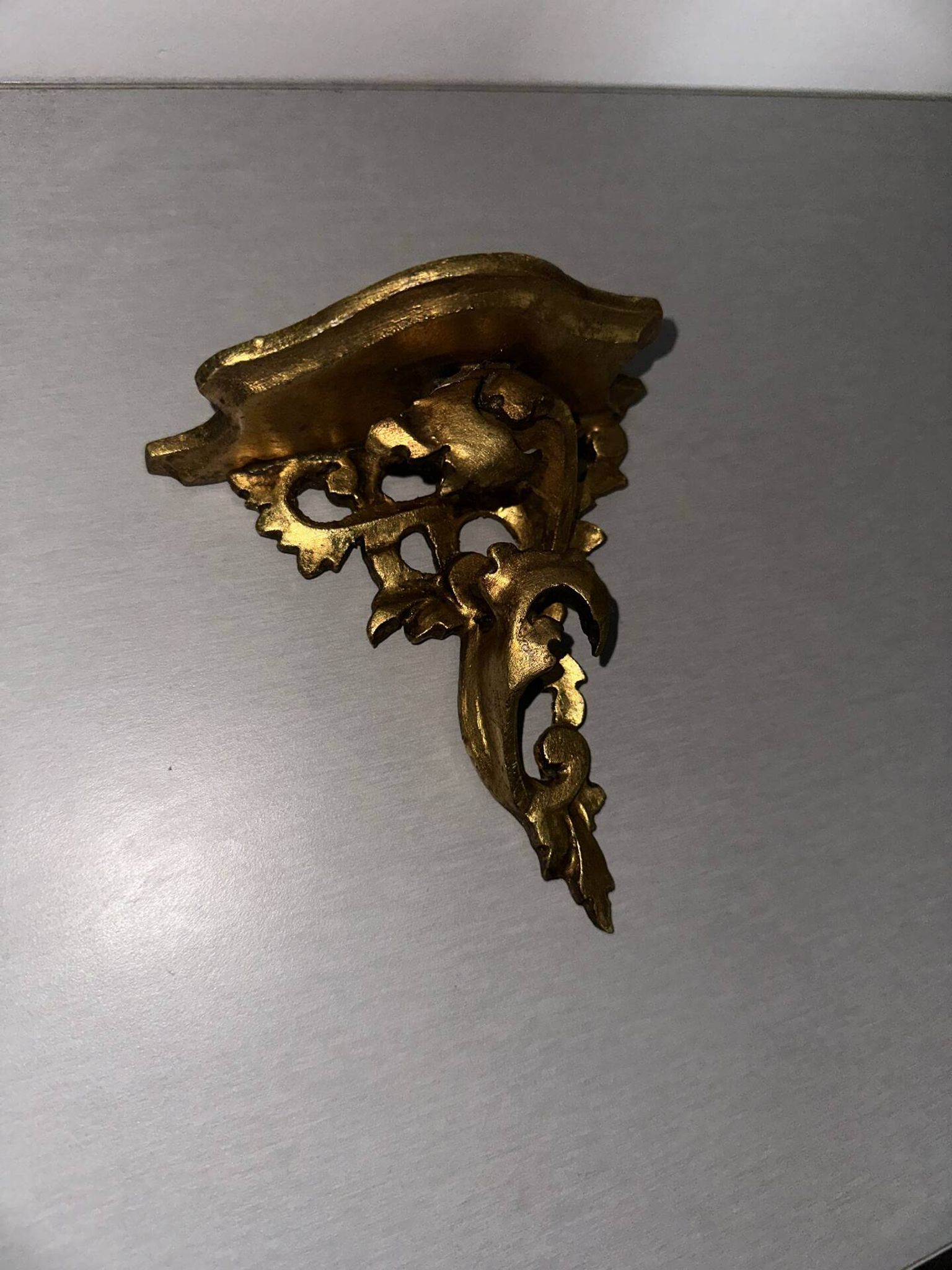 Antique wall-mounted console in gilded wood in rococo style.