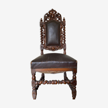 Antique chair in carved and turned wood, seat and back leather and studded