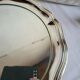 Round silver-plated serving dish with a glass base.