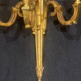 Pair of gilt bronze wall sconces with three lights in the Louis XVI style.