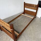 Brutalist style bed with chain and straw