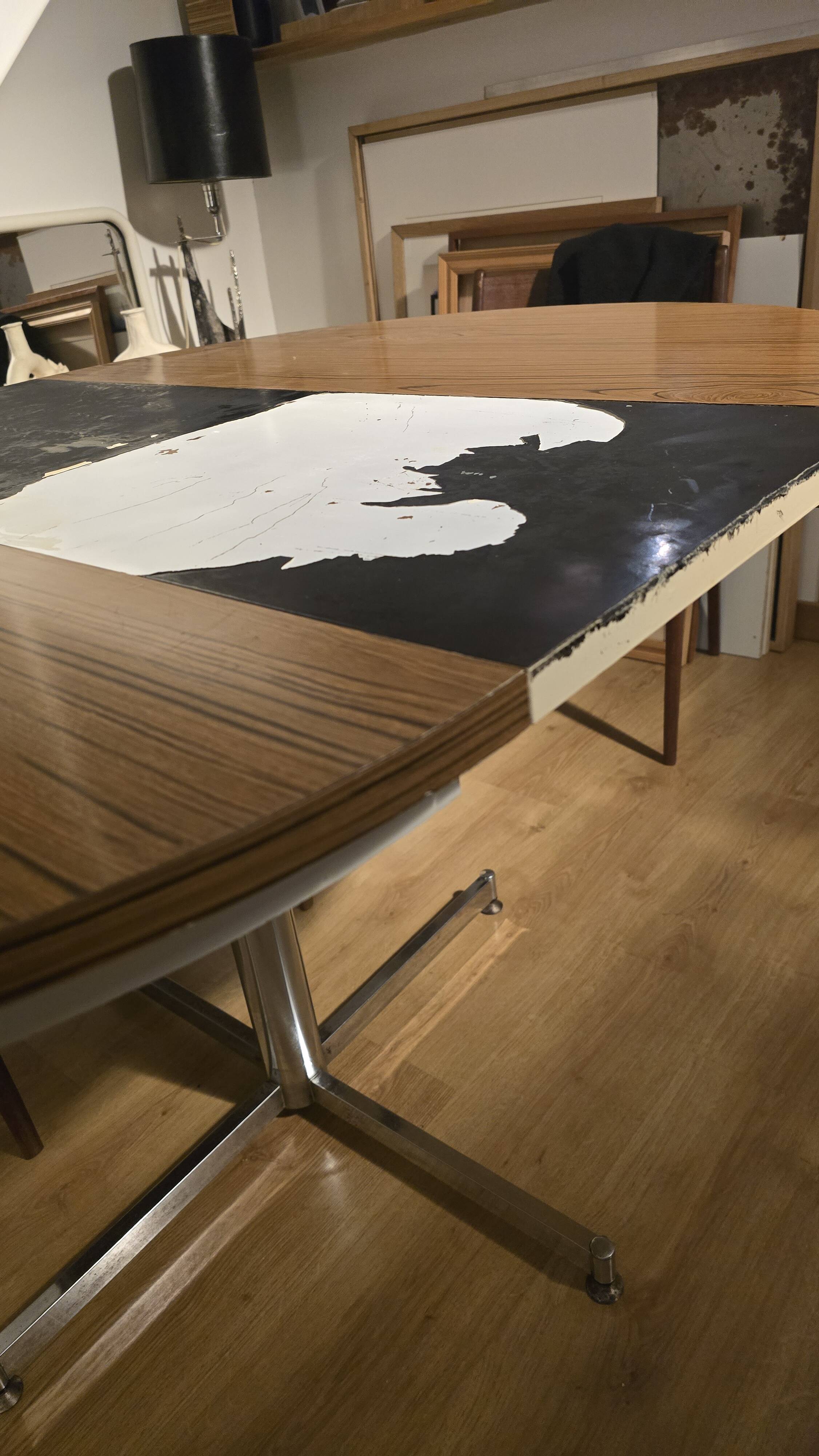 Extendable round table with a space age vintage mid-century formica top.