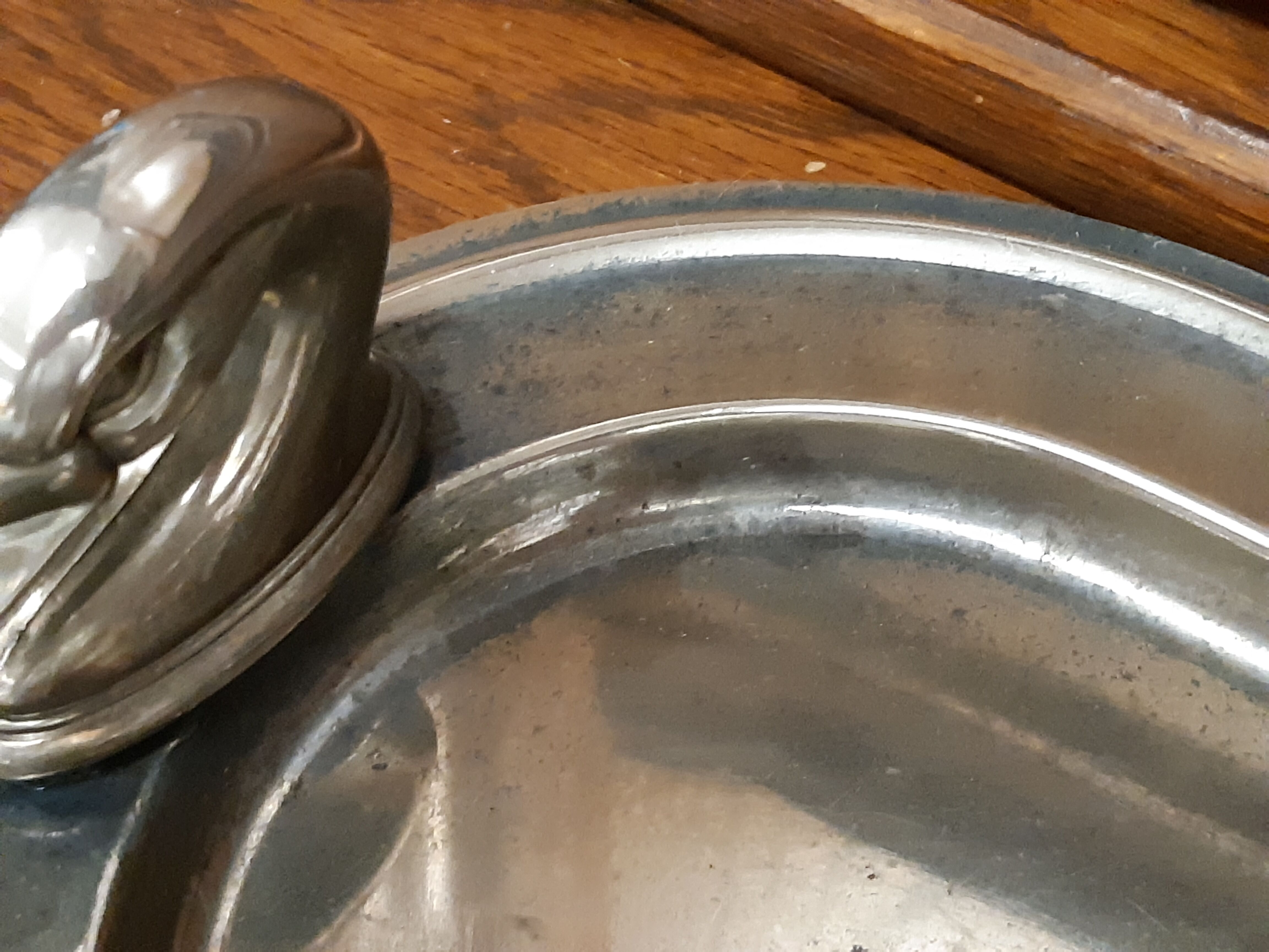 Silver dish with foie gras, duck heads