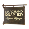 Former sign of the store "Marchand Drapier"