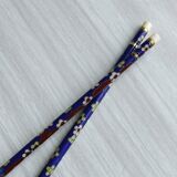 Blue chopsticks decorated with floral motifs.