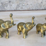 Three brass elephants