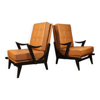 Pair of vintage 1950s armchairs in black wood and caramel leather.