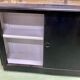 Store window with sliding doors in matte black patinated oak - 30s