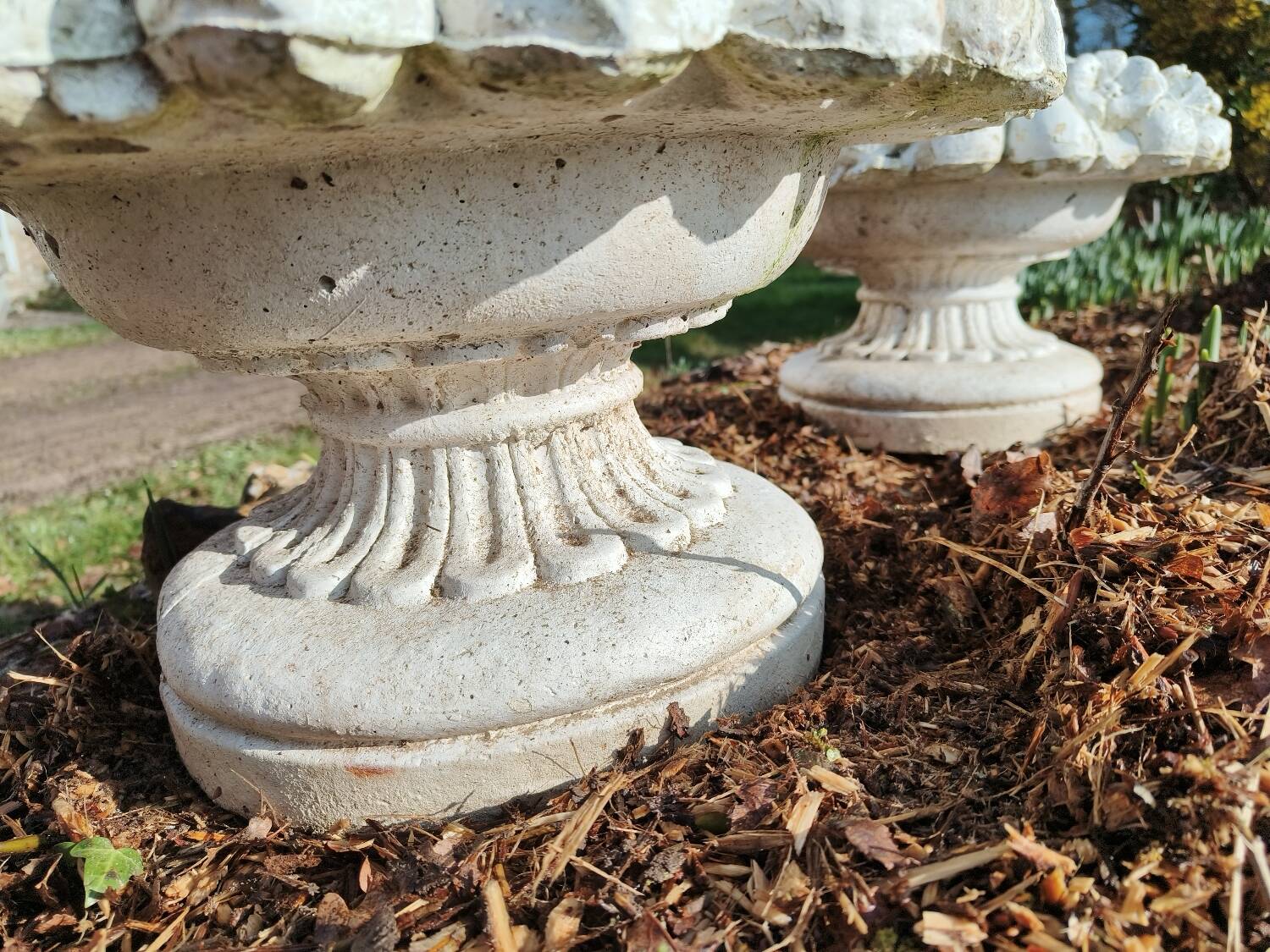 Pair of round stone fruit bowls on foot
