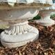 Pair of round stone fruit bowls on foot