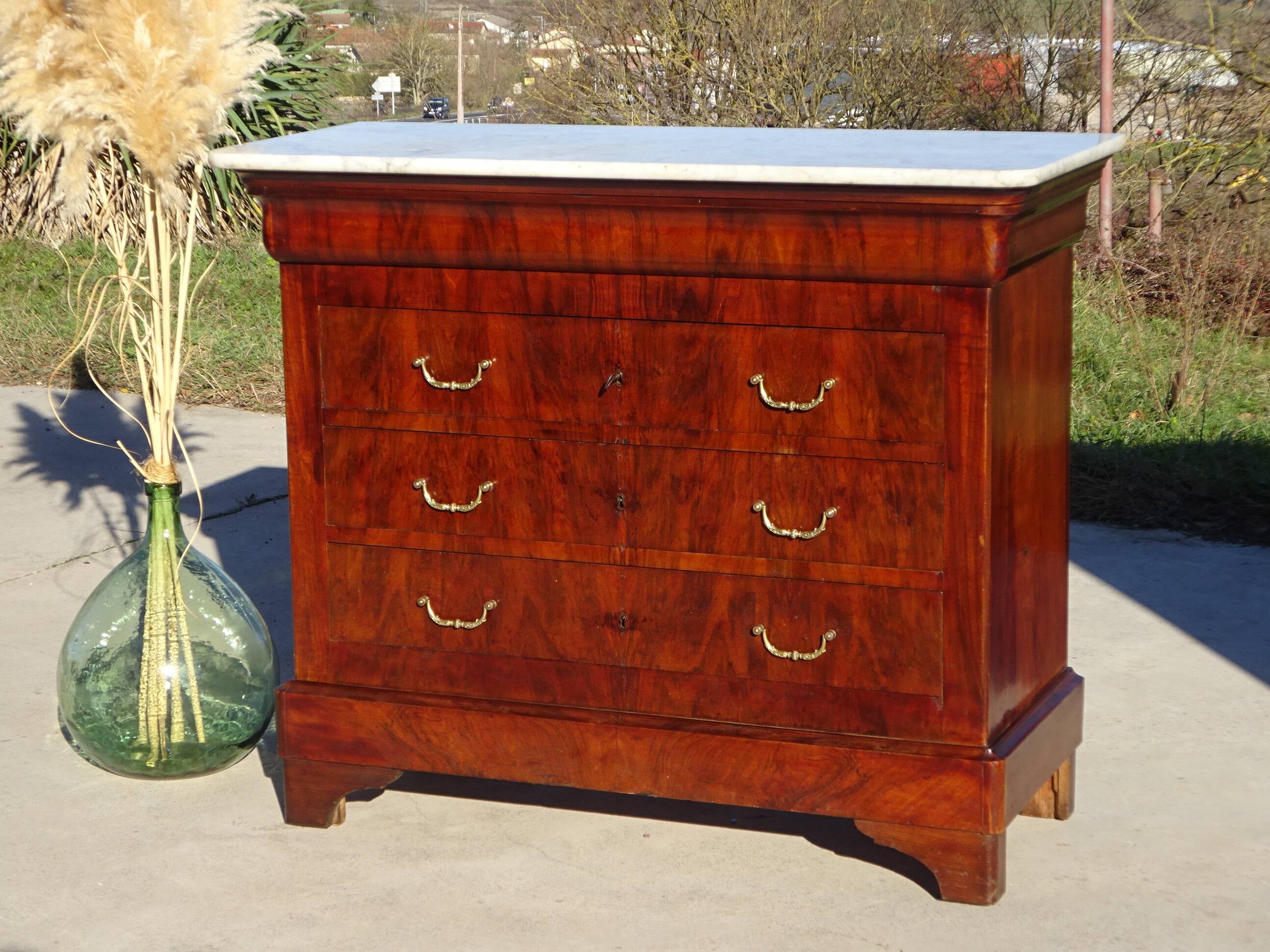 Antique mahogany chest of drawers with white marble.