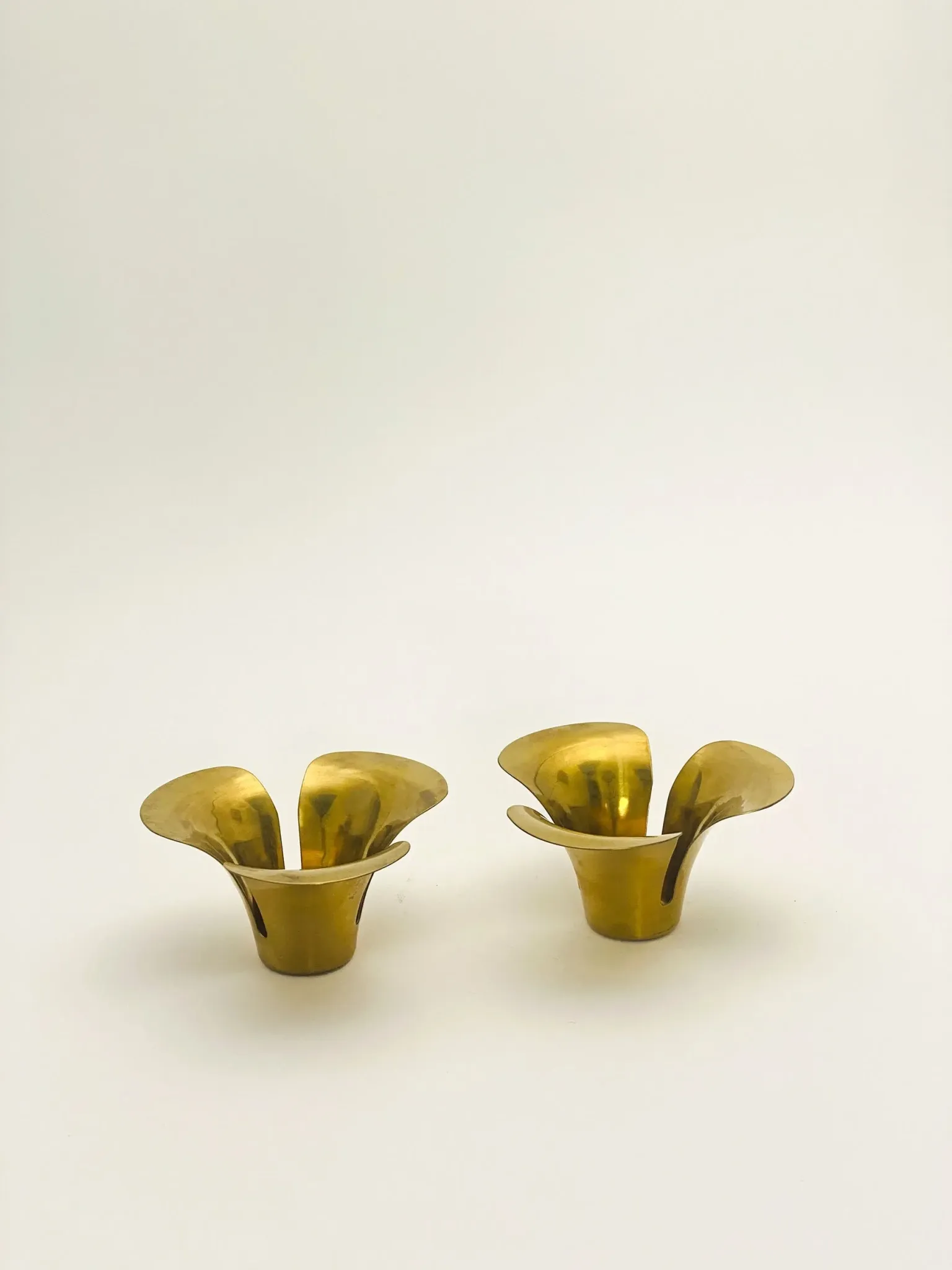 Brass candle holders in the shape of a flower.