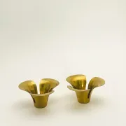 Brass candle holders in the shape of a flower.