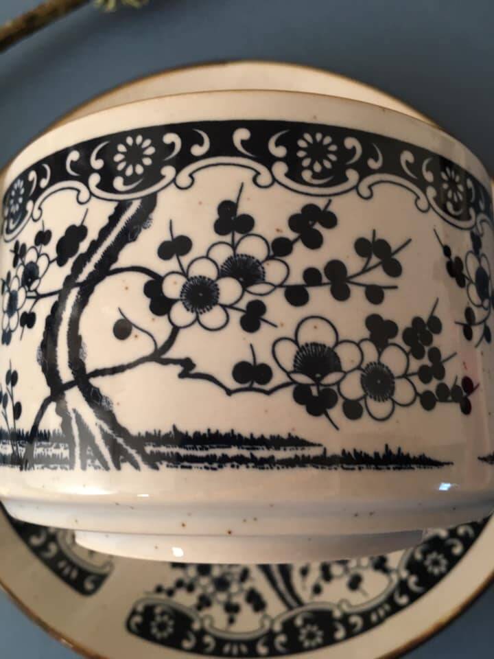 Large stoneware cup and saucer with delicate floral patterns
