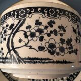 Large stoneware cup and saucer with delicate floral patterns