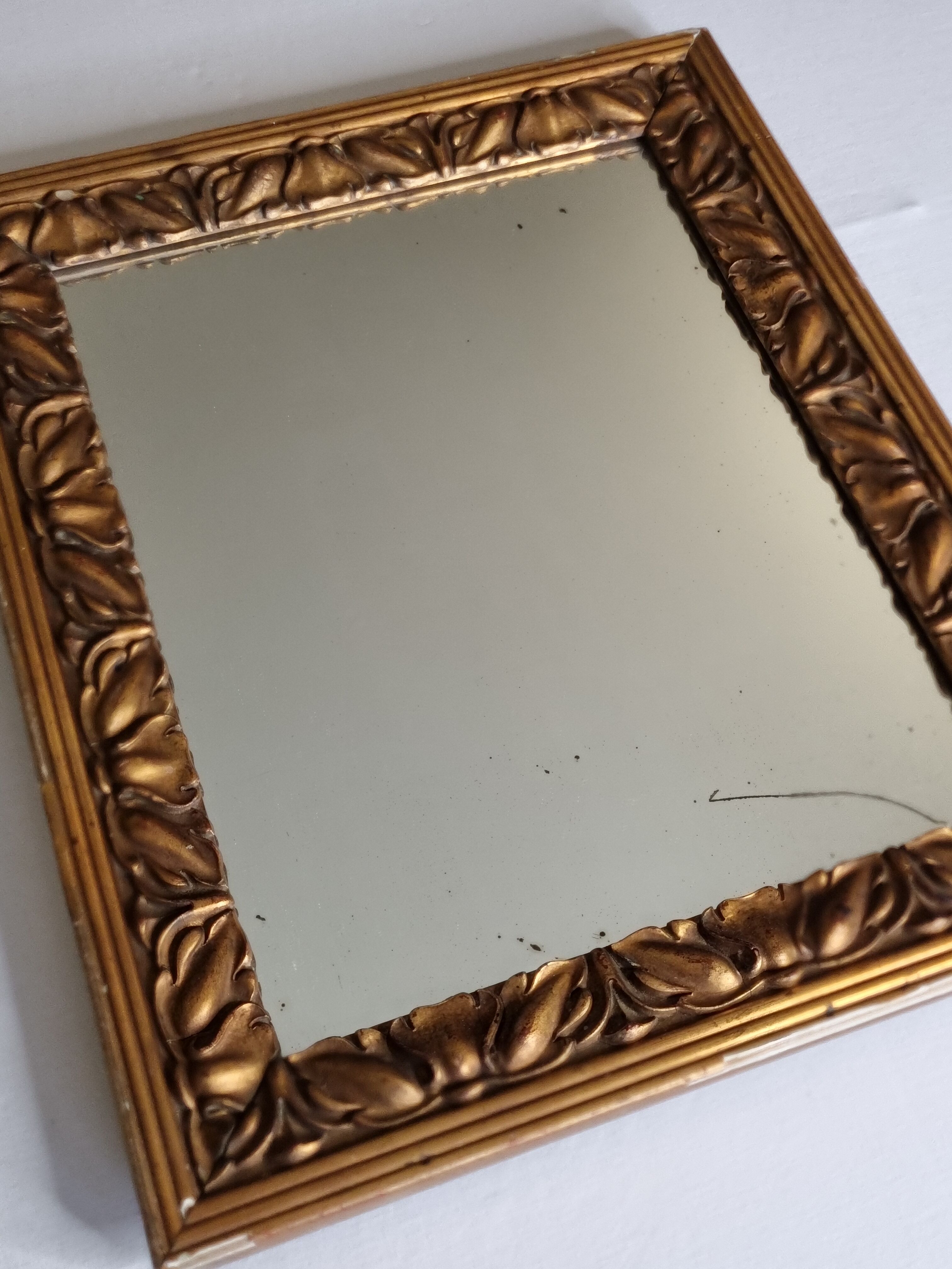 Patinated golden rectangular mirror, decorated with acanthus leaves, 49 cm